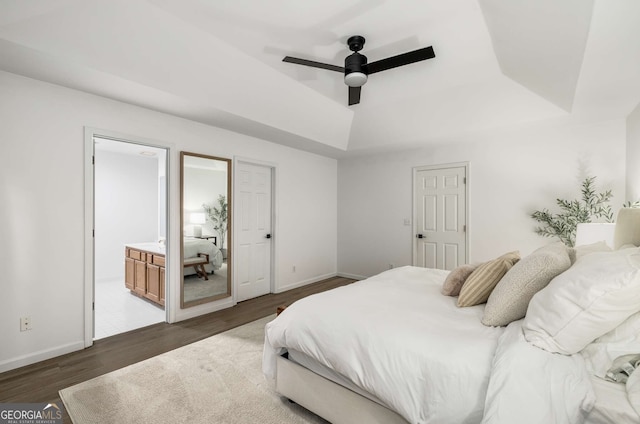 5315 Bentley Hall Dr, Alpharetta, GA 30005 - bedroom with a tray ceiling, wood finished floors, connected bathroom, and a ceiling fan
