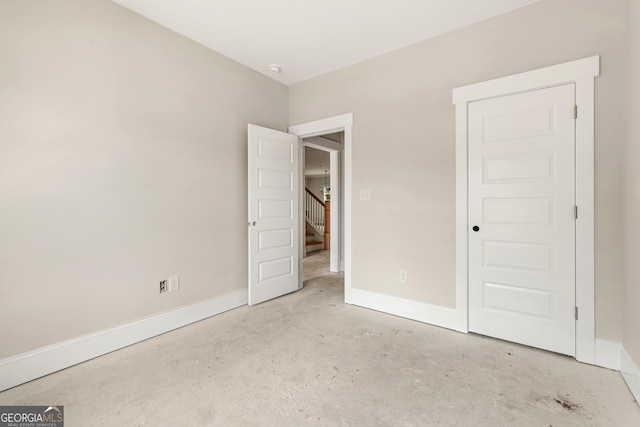 195 Grove Point Rd, Athens, GA 30605 - unfurnished bedroom featuring unfinished concrete flooring and baseboards