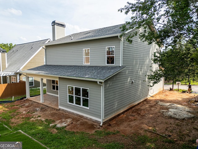 195 Grove Point Rd, Athens, GA 30605 - rear view of property featuring a patio area, a shingled roof, and a chimney