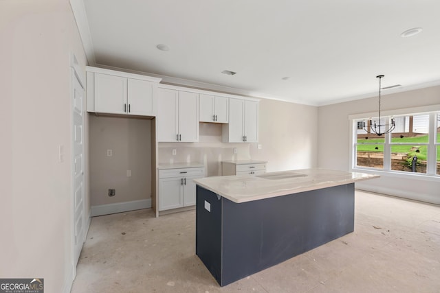 195 Grove Point Rd, Athens, GA 30605 - kitchen with white cabinetry, a chandelier, a kitchen island, hanging light fixtures, and ornamental molding