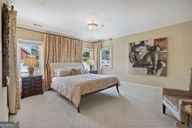 2883 Andrews Dr NW, Atlanta, GA 30305 - bedroom featuring multiple windows, light colored carpet, and crown molding
