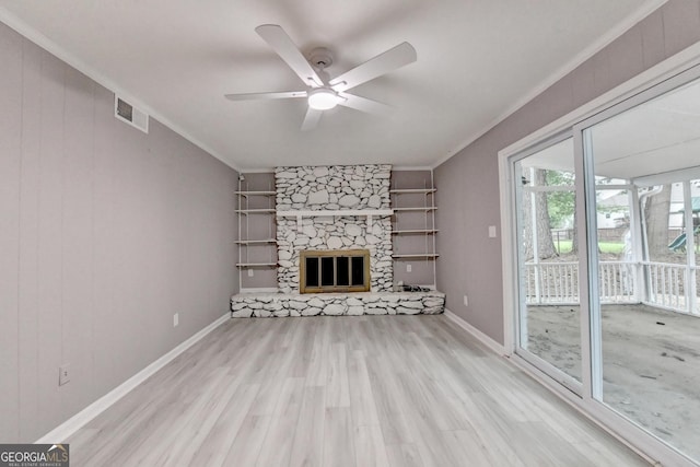 1094 SW Amber Rdg SW, Lilburn, GA 30047 - unfurnished living room featuring ornamental molding, wood finished floors, a ceiling fan, and a fireplace