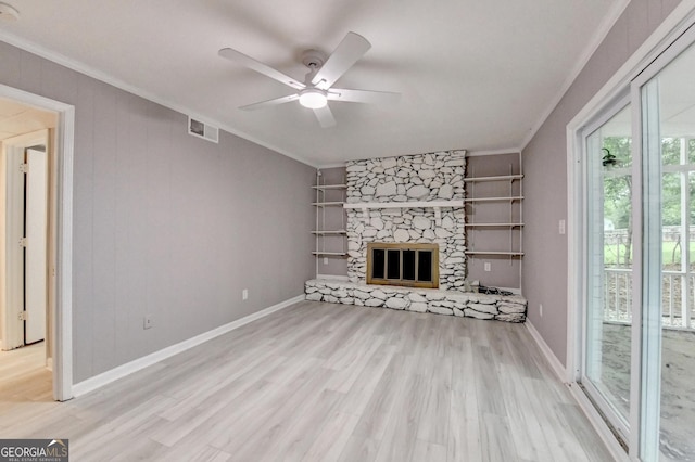 1094 SW Amber Rdg SW, Lilburn, GA 30047 - unfurnished living room featuring ornamental molding, wood finished floors, a ceiling fan, and a stone fireplace