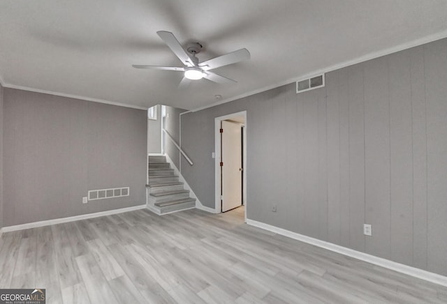 1094 SW Amber Rdg SW, Lilburn, GA 30047 - empty room with a ceiling fan, stairway, wood finished floors, and ornamental molding