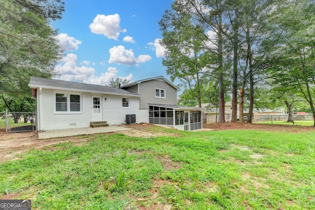 1094 SW Amber Rdg SW, Lilburn, GA 30047 - back of house featuring a sunroom, brick siding, roof with shingles, and a patio
