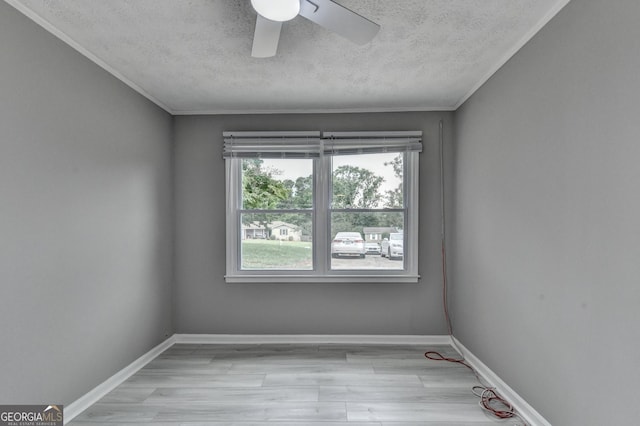1094 SW Amber Rdg SW, Lilburn, GA 30047 - empty room with a textured ceiling, light wood-style flooring, ceiling fan, and ornamental molding