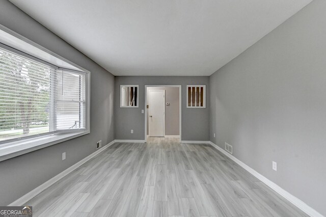 1094 SW Amber Rdg SW, Lilburn, GA 30047 - unfurnished living room featuring baseboards and light wood finished floors