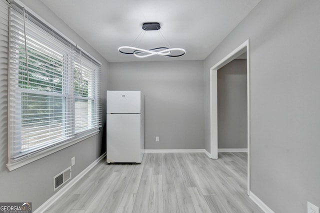 1094 SW Amber Rdg SW, Lilburn, GA 30047 - unfurnished dining area featuring light wood-type flooring and a chandelier