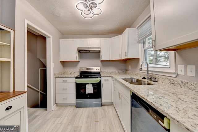 1094 SW Amber Rdg SW, Lilburn, GA 30047 - kitchen with stainless steel appliances, under cabinet range hood, light wood-style flooring, white cabinetry, and light stone countertops