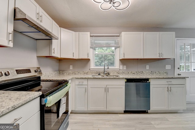 1094 SW Amber Rdg SW, Lilburn, GA 30047 - kitchen with stainless steel appliances, under cabinet range hood, white cabinets, and light wood-style floors