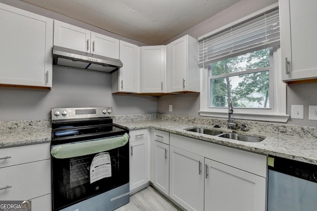 1094 SW Amber Rdg SW, Lilburn, GA 30047 - kitchen with appliances with stainless steel finishes, under cabinet range hood, white cabinets, light stone countertops, and a textured ceiling