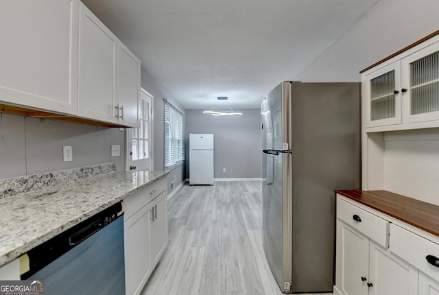 1094 SW Amber Rdg SW, Lilburn, GA 30047 - kitchen featuring freestanding refrigerator, dishwasher, white cabinets, and light wood-style flooring
