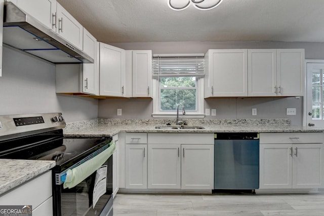 1094 SW Amber Rdg SW, Lilburn, GA 30047 - kitchen featuring appliances with stainless steel finishes, under cabinet range hood, healthy amount of natural light, white cabinets, and a textured ceiling
