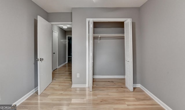 1094 SW Amber Rdg SW, Lilburn, GA 30047 - unfurnished bedroom with a closet and light wood-style floors