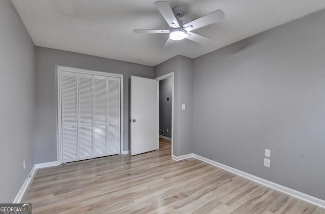1094 SW Amber Rdg SW, Lilburn, GA 30047 - unfurnished bedroom featuring a closet, light wood-type flooring, and a ceiling fan