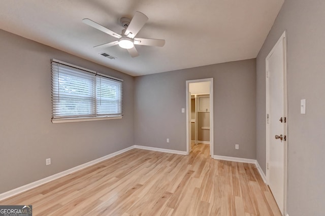 1094 SW Amber Rdg SW, Lilburn, GA 30047 - unfurnished bedroom with light wood-type flooring, ceiling fan, a spacious closet, and a closet