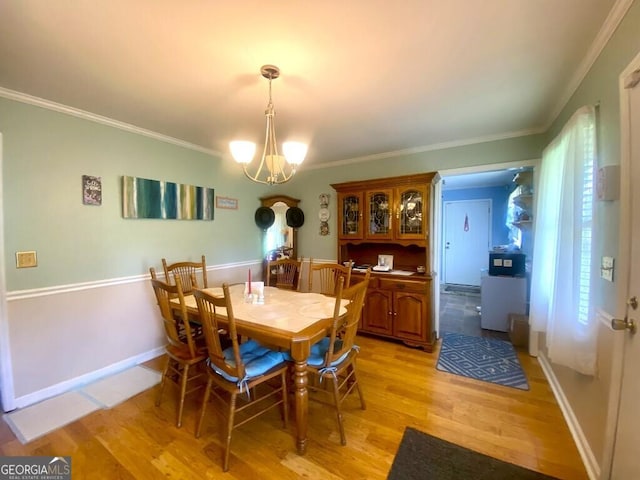 2557 Bartley Rd, Lagrange, GA 30240 - dining area with light wood finished floors, crown molding, and a chandelier