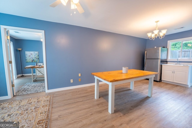 46 Wall Street Way, Toccoa, GA 30577 - dining space featuring light wood finished floors, a chandelier, and a ceiling fan