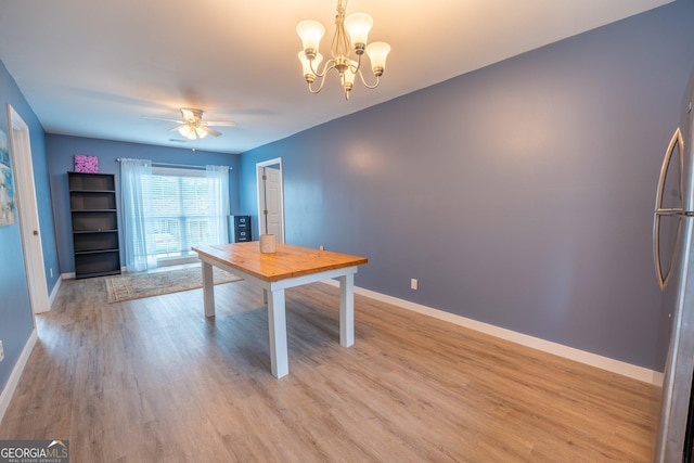 46 Wall Street Way, Toccoa, GA 30577 - unfurnished dining area with a ceiling fan, light wood-style flooring, and a chandelier