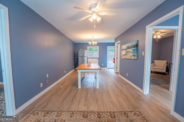 46 Wall Street Way, Toccoa, GA 30577 - unfurnished dining area featuring a ceiling fan, light wood finished floors, and a chandelier
