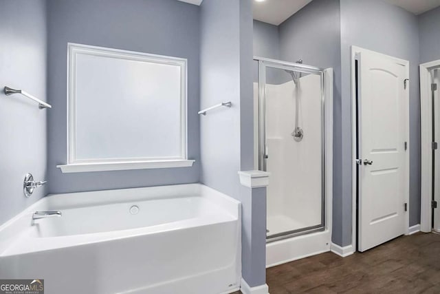 132 Berkleigh Trails Dr, Hiram, GA 30141 - full bathroom with a stall shower, a bath, and wood finished floors
