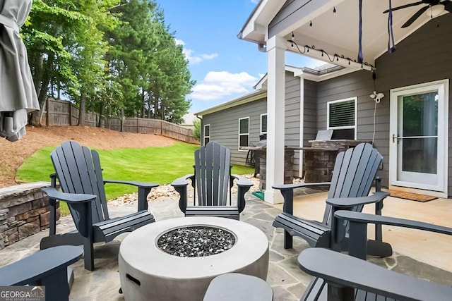 132 Berkleigh Trails Dr, Hiram, GA 30141 - fenced backyard with a fire pit, a patio, ceiling fan, and area for grilling