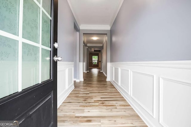 132 Berkleigh Trails Dr, Hiram, GA 30141 - hallway with crown molding, a decorative wall, light wood-style flooring, and a wainscoted wall