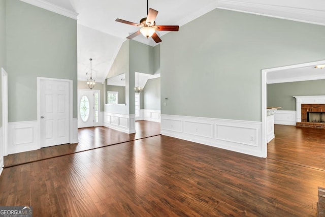 4371 Shag Bark Trl, Gainesville, GA 30507 - unfurnished living room with a chandelier, ceiling fan, high vaulted ceiling, wainscoting, and wood-type flooring