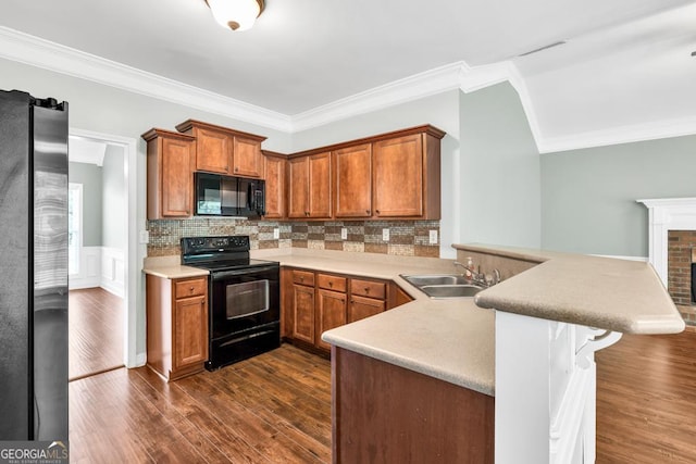 4371 Shag Bark Trl, Gainesville, GA 30507 - kitchen featuring black appliances, a peninsula, ornamental molding, dark wood-type flooring, and backsplash