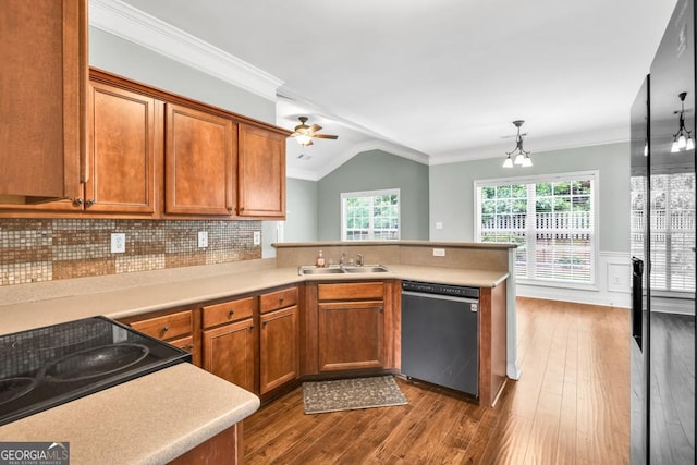 4371 Shag Bark Trl, Gainesville, GA 30507 - kitchen featuring appliances with stainless steel finishes, a peninsula, brown cabinetry, vaulted ceiling, and light countertops