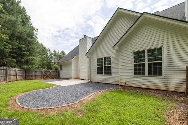 4371 Shag Bark Trl, Gainesville, GA 30507 - back of house featuring a patio and a chimney