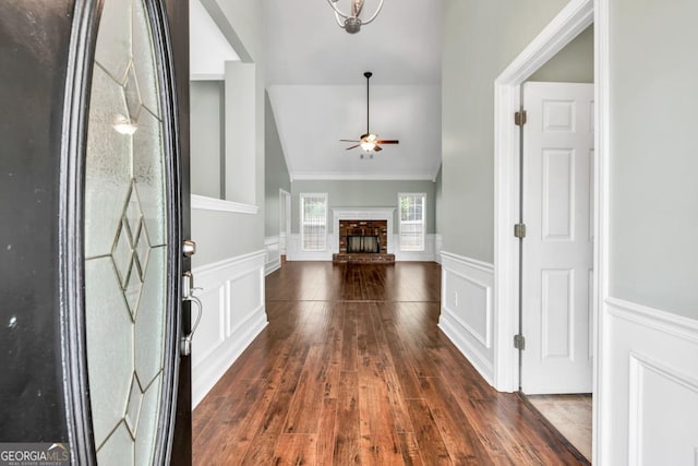 4371 Shag Bark Trl, Gainesville, GA 30507 - entrance foyer featuring a ceiling fan, wainscoting, a decorative wall, wood-type flooring, and a brick fireplace
