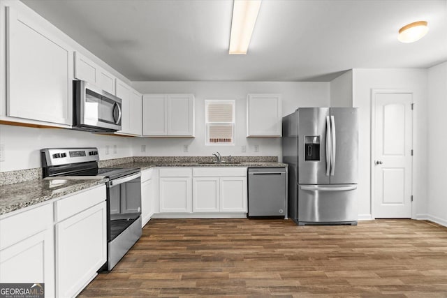 104 Middleton Ct, Chatsworth, GA 30705 - kitchen featuring appliances with stainless steel finishes, white cabinetry, dark wood finished floors, and stone counters