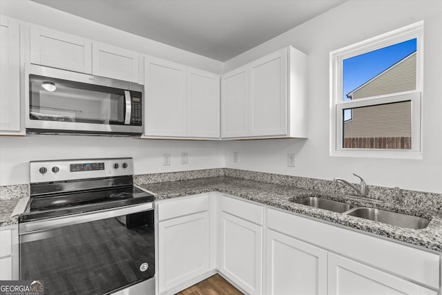 104 Middleton Ct, Chatsworth, GA 30705 - kitchen with stainless steel appliances, white cabinetry, and light stone countertops