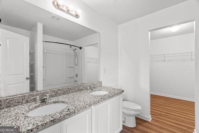 104 Middleton Ct, Chatsworth, GA 30705 - full bathroom featuring a shower, double vanity, wood finished floors, and a walk in closet