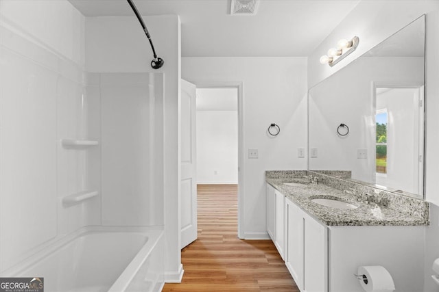 104 Middleton Ct, Chatsworth, GA 30705 - bathroom featuring bathtub / shower combination, double vanity, and wood finished floors