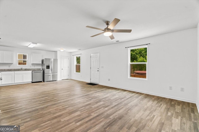 104 Middleton Ct, Chatsworth, GA 30705 - unfurnished living room with ceiling fan and light wood-type flooring