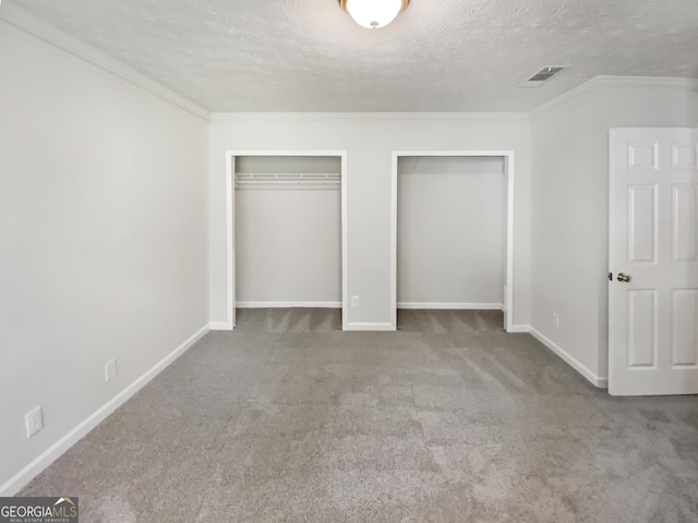 1480 D NE Pine Log Rd Unit D, Conyers, GA 30012 - unfurnished bedroom with two closets, carpet flooring, a textured ceiling, and crown molding