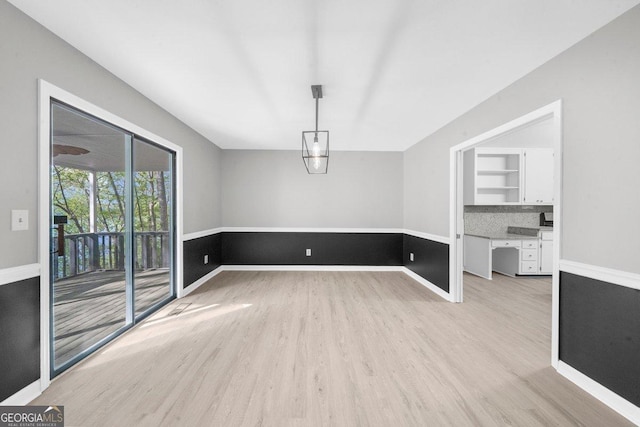 2945 Thompson Mill Rd, Gainesville, GA 30506 - unfurnished dining area with light wood-style floors and baseboards