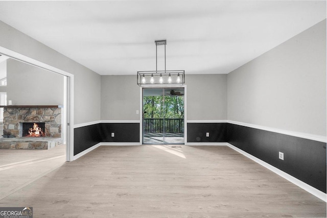 2945 Thompson Mill Rd, Gainesville, GA 30506 - unfurnished dining area with wood finished floors and a stone fireplace