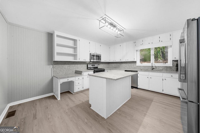 2945 Thompson Mill Rd, Gainesville, GA 30506 - kitchen with appliances with stainless steel finishes, light wood-style flooring, open shelves, and white cabinetry
