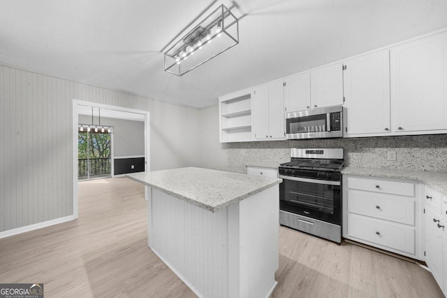 2945 Thompson Mill Rd, Gainesville, GA 30506 - kitchen featuring appliances with stainless steel finishes, open shelves, light wood-style flooring, and white cabinets