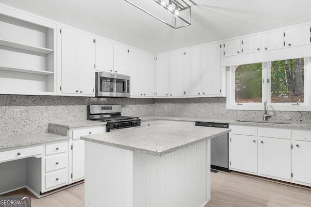 2945 Thompson Mill Rd, Gainesville, GA 30506 - kitchen with appliances with stainless steel finishes, white cabinets, light wood-style floors, and light stone counters