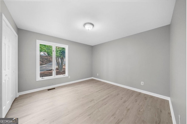 2945 Thompson Mill Rd, Gainesville, GA 30506 - unfurnished bedroom featuring light wood finished floors and a closet