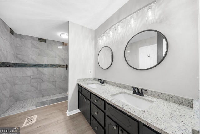 2945 Thompson Mill Rd, Gainesville, GA 30506 - bathroom featuring double vanity, walk in shower, and wood finished floors
