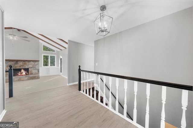 2945 Thompson Mill Rd, Gainesville, GA 30506 - hallway with wood finished floors, an upstairs landing, and a chandelier