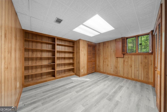 2945 Thompson Mill Rd, Gainesville, GA 30506 - empty room featuring light wood finished floors, wooden walls, and built in features