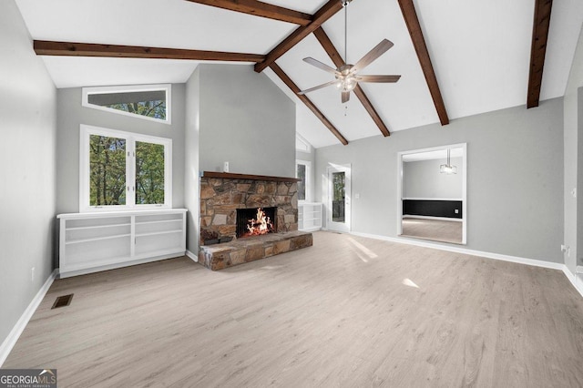 2945 Thompson Mill Rd, Gainesville, GA 30506 - unfurnished living room featuring wood finished floors, beam ceiling, a fireplace, a ceiling fan, and high vaulted ceiling