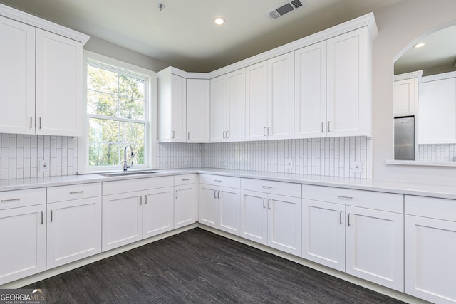 288 Oliver Dr, Locust Grove, GA 30248 - kitchen with light countertops, arched walkways, white cabinets, tasteful backsplash, and recessed lighting