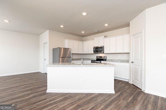 288 Oliver Dr, Locust Grove, GA 30248 - kitchen with stainless steel appliances, dark wood-style flooring, white cabinets, recessed lighting, and a kitchen island with sink